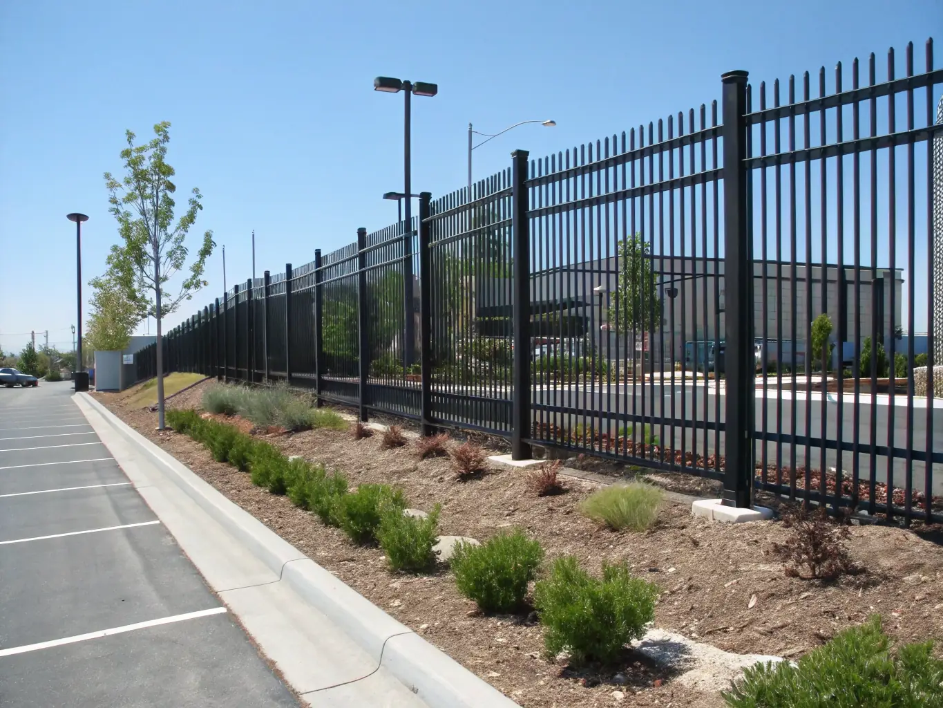 A sleek metal fence surrounding a commercial property, emphasizing its strength and security features.